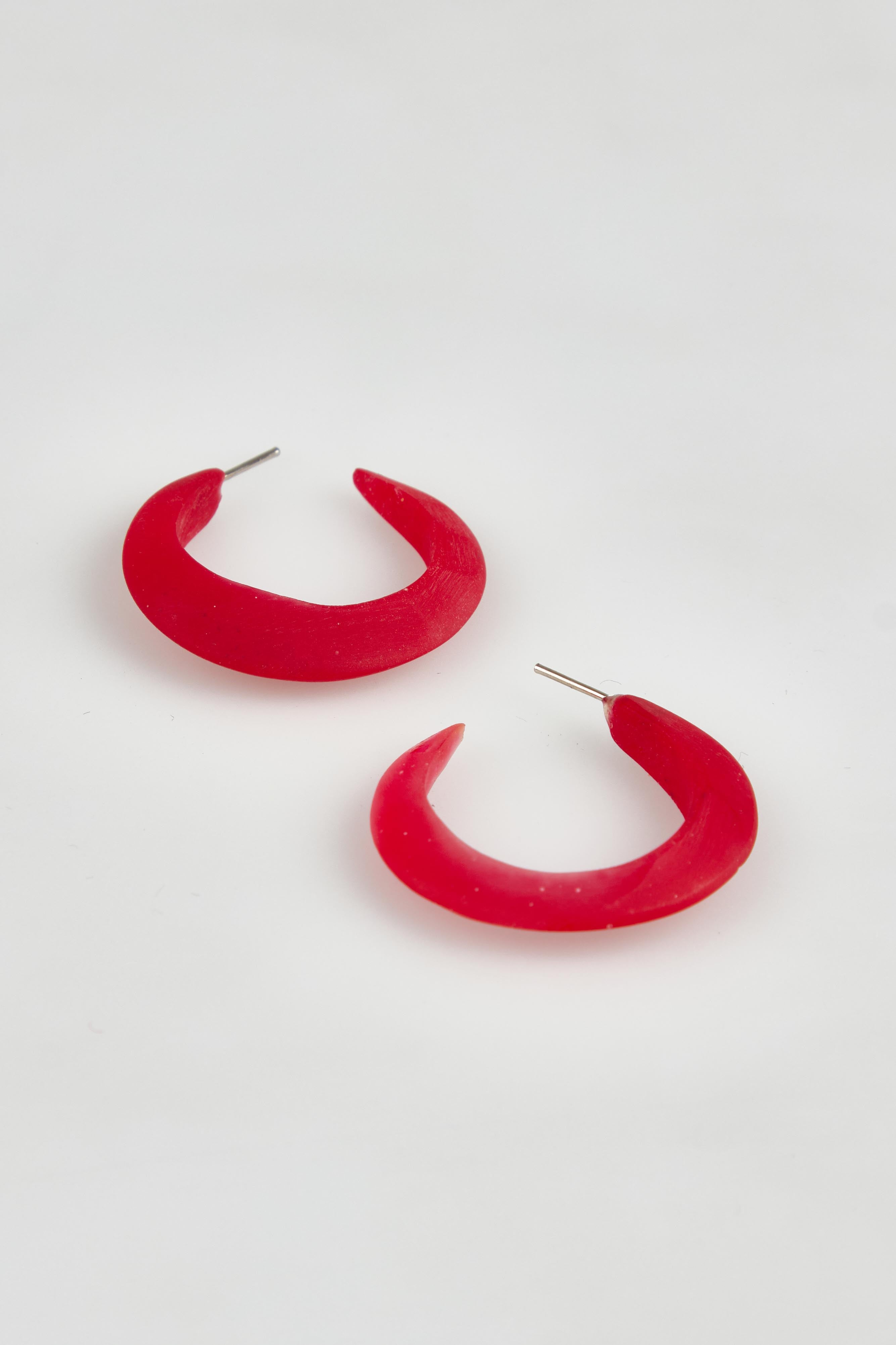 A model wearing the Point Finish Resin Hoop Earring in colour Red (Red), from the front, showing the whole outfit