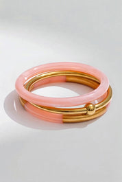 Product shot of the Riviera 3 Stack Bangle - Pink in colour Pink, from the front