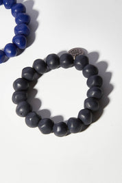 A model wearing size OneSize of the Rock Resin Bracelet in colour Navy (Blue), from the front, showing the whole outfit