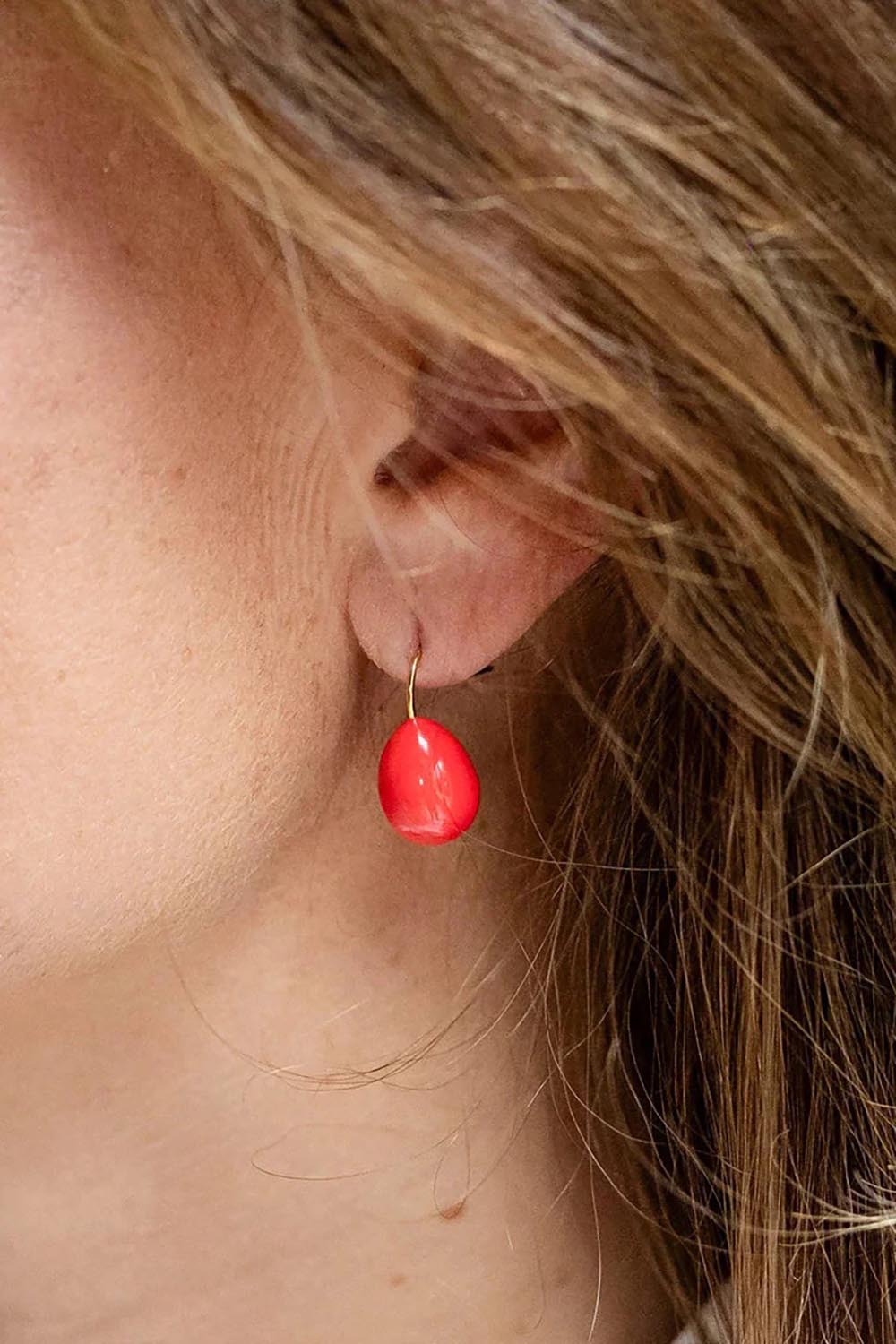 Model Genericm wearing size sample of the Alice Enamel Drop Earrings - Brightcoral in colour Brightcoral, from an angle