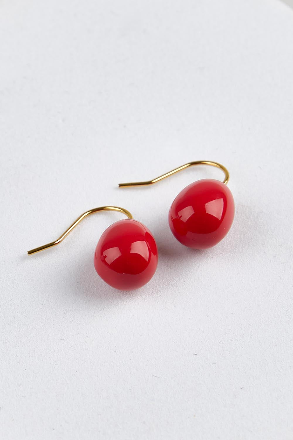 Model Genericm wearing size sample of the Alice Enamel Drop Earrings - Red in colour Red, from an angle