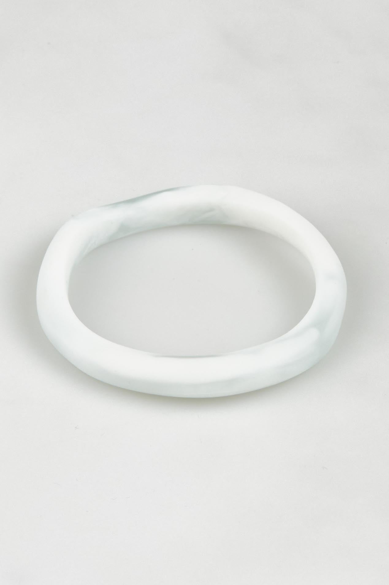 A model wearing the Wave Resin Stacking Bangle in colour White (White), from the front, showing the whole outfit