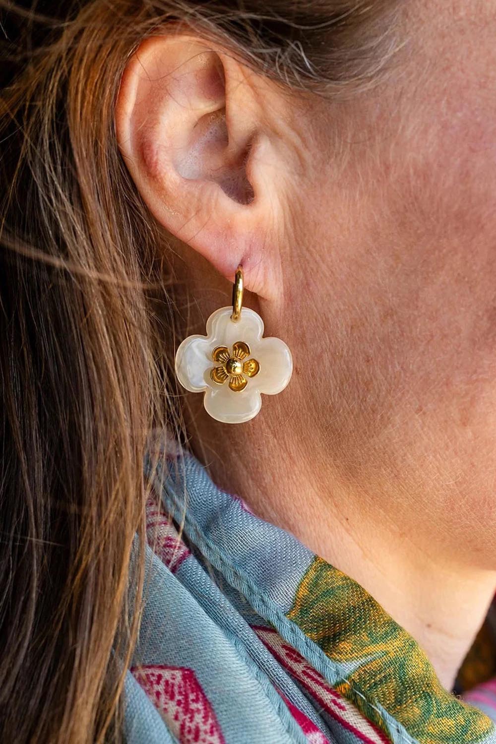 Model Genericm wearing size sample of the Willa Flower Hoop Earring - Cream in colour Cream, from an angle