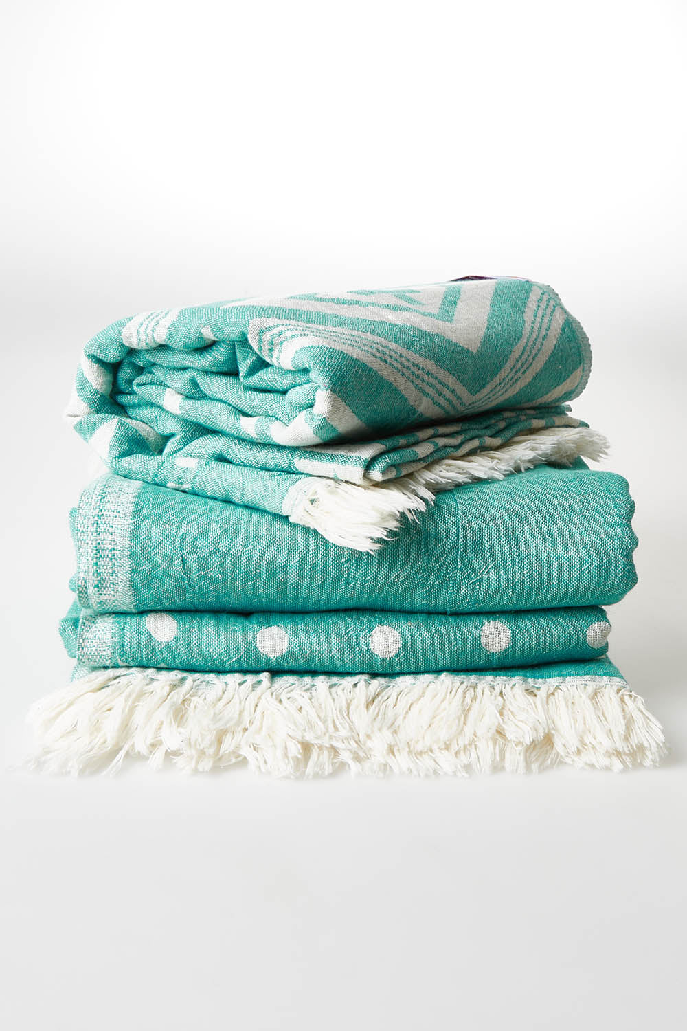 A model wearing size OneSize of the Hammamas Aztec Cotton Towel in colour Emerald (Green), from the front, showing the whole outfit