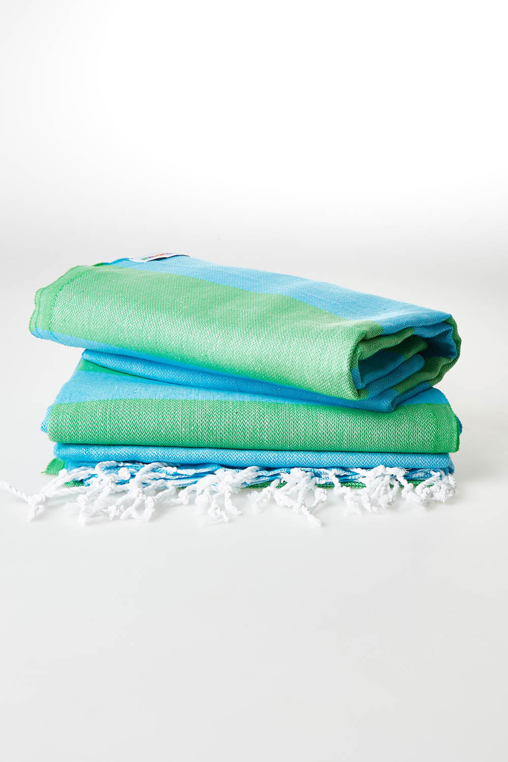 A model wearing size OneSize of the Hammamas Bold Cotton Towel in colour Appleaqua (Green), from the front, showing the whole outfit