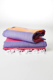A model wearing size OneSize of the Hammamas Clash Towel in colour Candyiris (Pink), from the front, showing the whole outfit