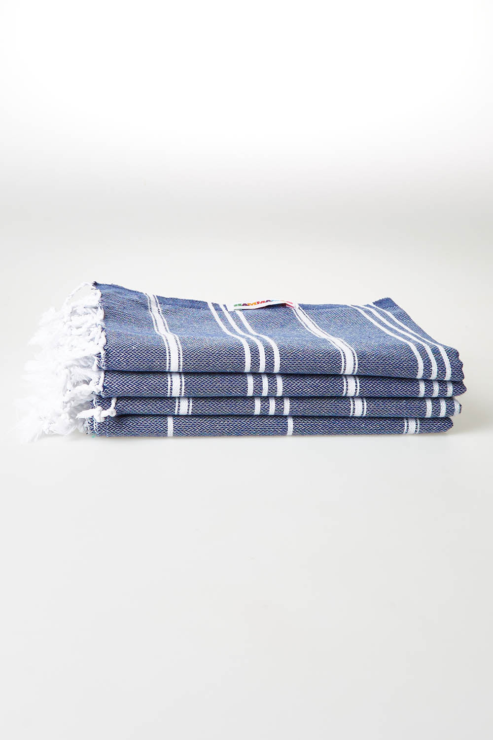 A model wearing size OneSize of the Hammamas Cotton Bubs Towel in colour Navy (Blue), from the front, showing the whole outfit