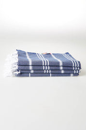 A model wearing size OneSize of the Hammamas Cotton Bubs Towel in colour Navy (Blue), from the front, showing the whole outfit
