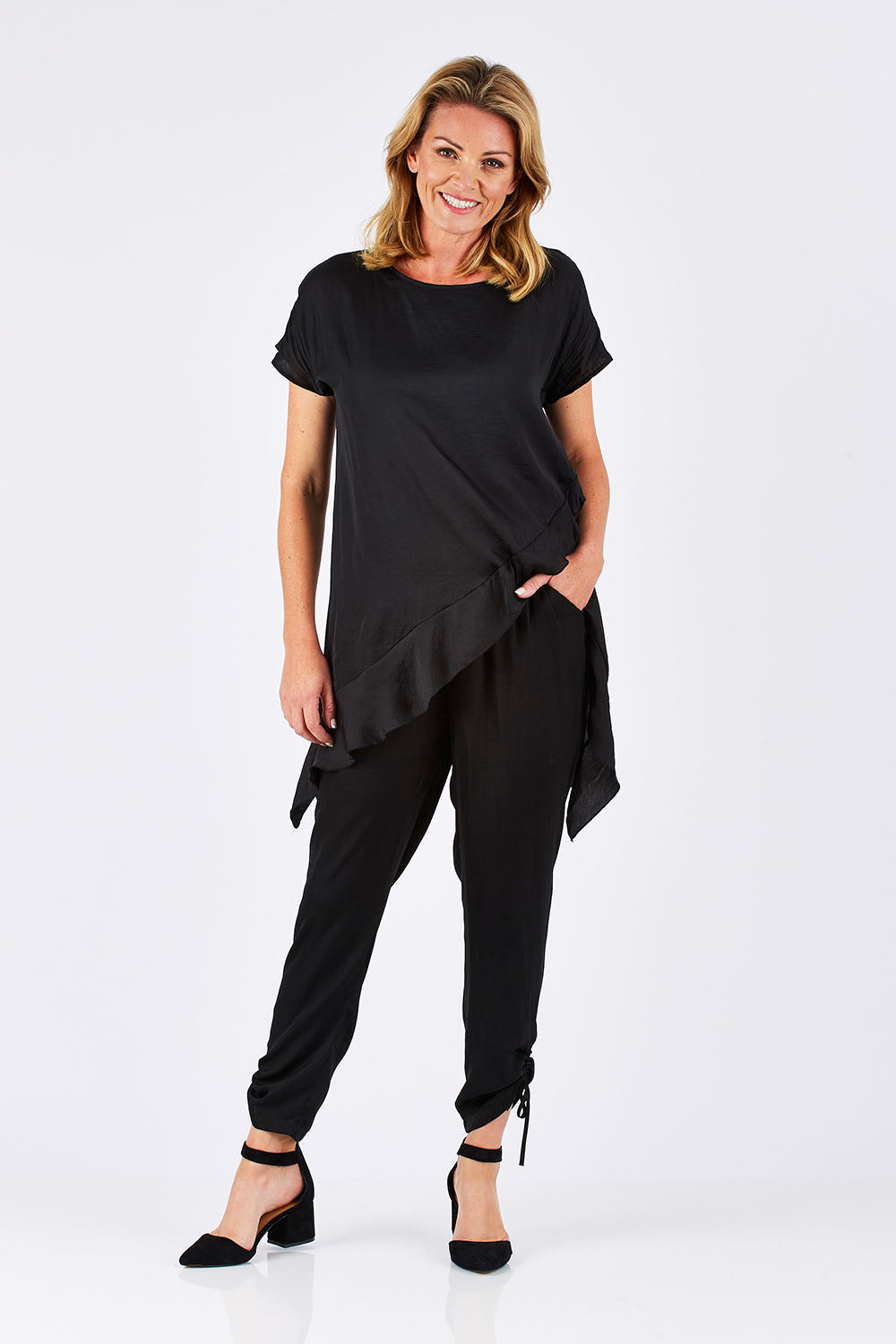 Model Louise wearing size 10 of the Luxe Pant in colour Black (Black), from the front, showing the whole outfit