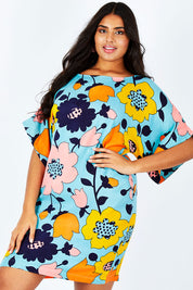 Model Shanaya wearing size 14 of the Bell Sleeve Tunic Dress in colour Flower (Blue), from the front, cropped image