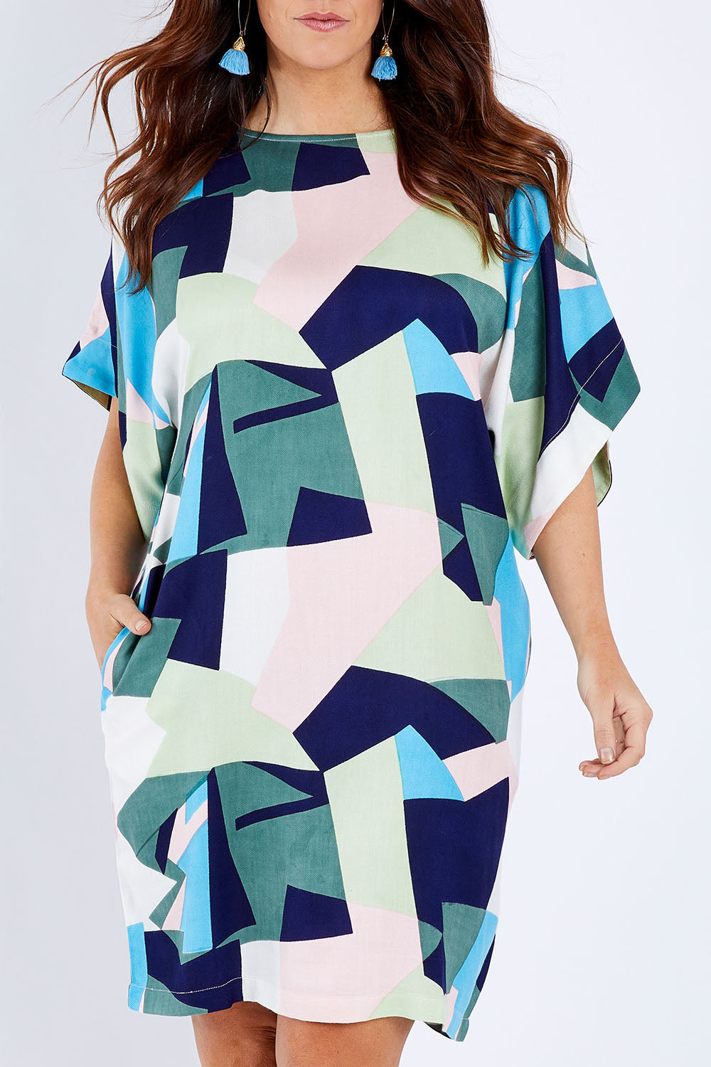 Model Laura wearing size 14 of the Bell Sleeve Tunic Dress in colour Geo (Blue), from the front, cropped image