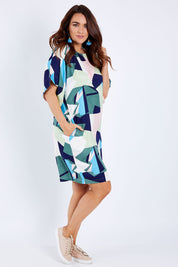 Model Laura wearing size 14 of the Bell Sleeve Tunic Dress in colour Geo (Blue), from the front, showing the whole outfit