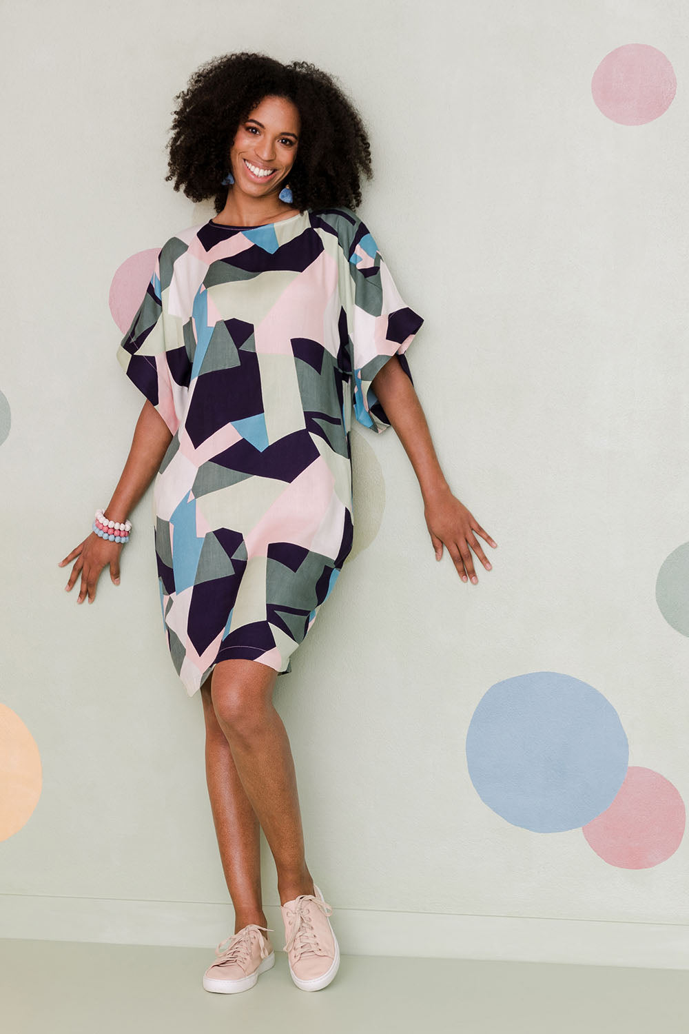 Model Schanez wearing size 10 of the Bell Sleeve Tunic Dress in colour Geo (Blue), from the front, showing the whole outfit