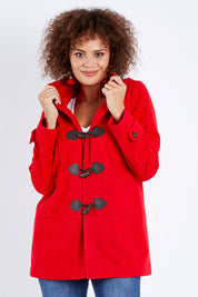 Model Lala wearing size 10 of the Duffle Jacket in colour Red (Red), from the front, cropped image