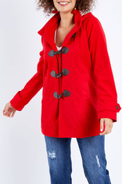 Model Lala wearing size 10 of the Duffle Jacket in colour Red (Red), from the front, cropped image