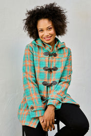 Model Olivia wearing size 10 of the Duffle Jacket in colour Checkered (Green), from the front, showing the whole outfit