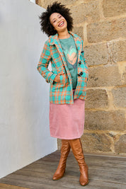 Model Olivia wearing size 10 of the Duffle Jacket in colour Checkered (Green), from the front, showing the whole outfit