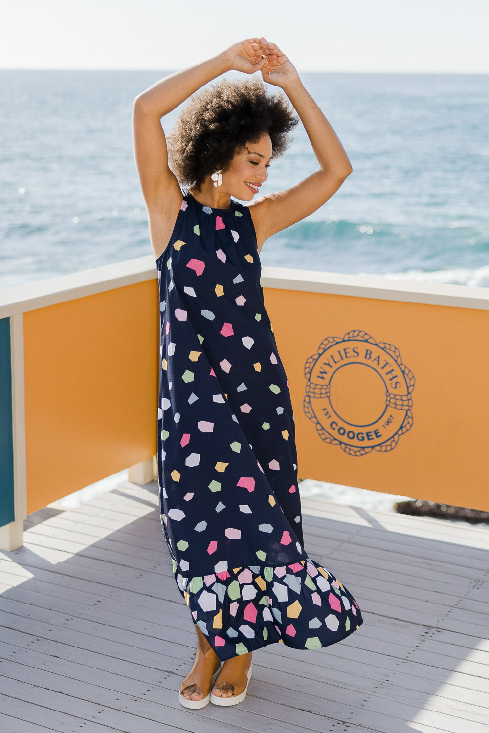 Model Olivia wearing size 10 of the Falling Bricks Maxi in colour Jigsaw (Blue), from the front, showing the whole outfit