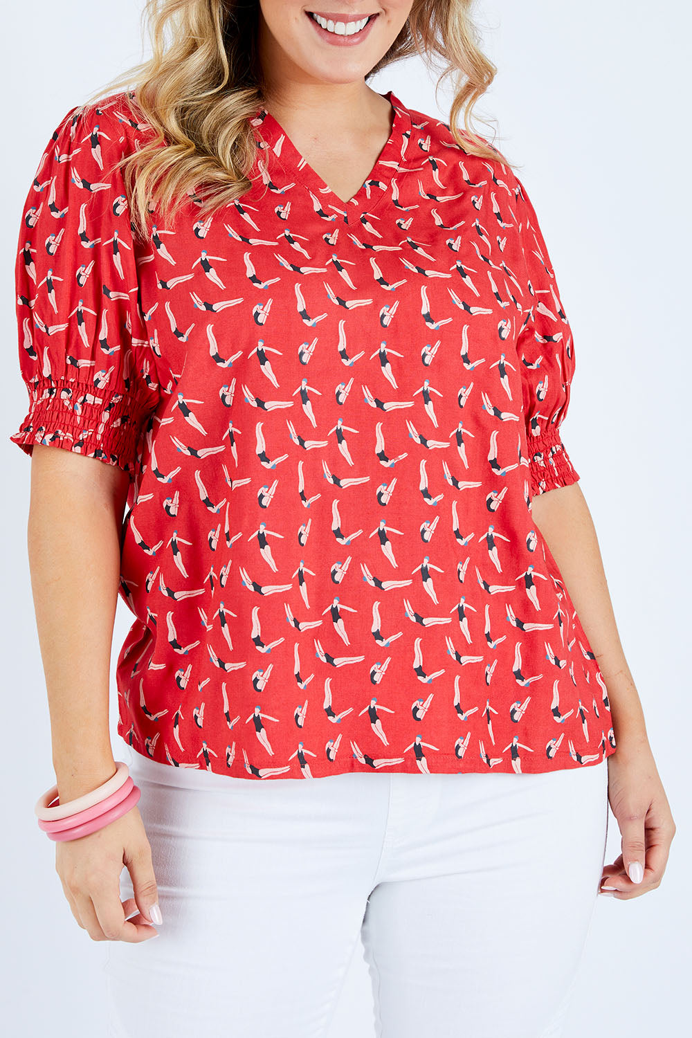 Model Jess wearing size 14 of the Printed V Neck Top in colour Diving (Pink), from the front, cropped image