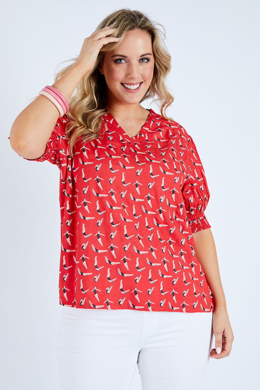 Model Jess wearing size 14 of the Printed V Neck Top in colour Diving (Pink), from the front, cropped image