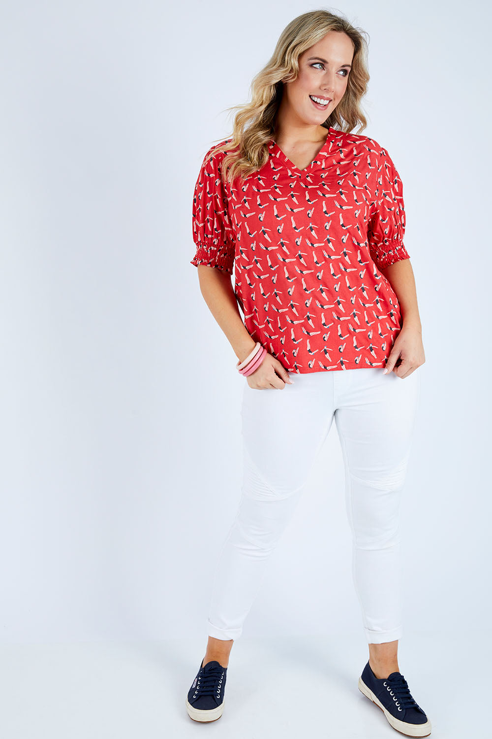 Model Jess wearing size 14 of the Printed V Neck Top in colour Diving (Pink), from the front, showing the whole outfit