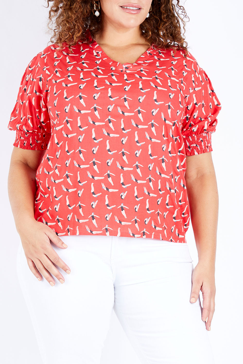 Model Jess wearing size 16 of the Printed V Neck Top in colour Diving (Pink), from the front, cropped image
