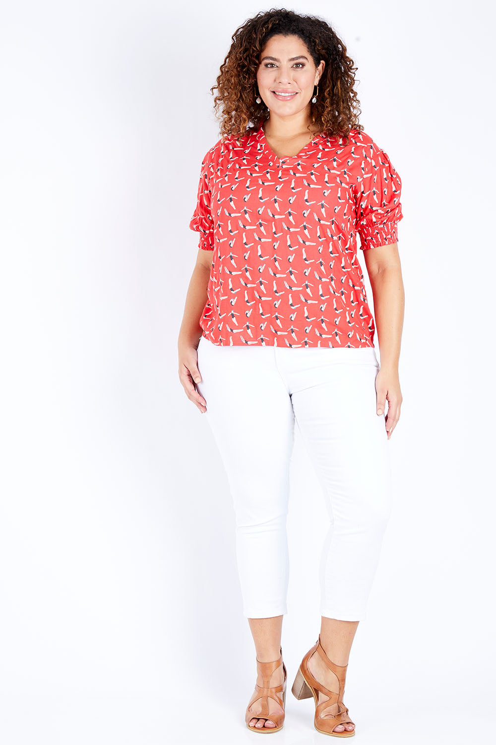 Model Jess wearing size 16 of the Printed V Neck Top in colour Diving (Pink), from the front, showing the whole outfit