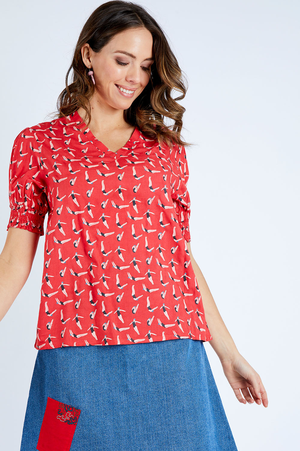 Model Madeline wearing size 10 of the Printed V Neck Top in colour Diving (Pink), from the front, cropped image