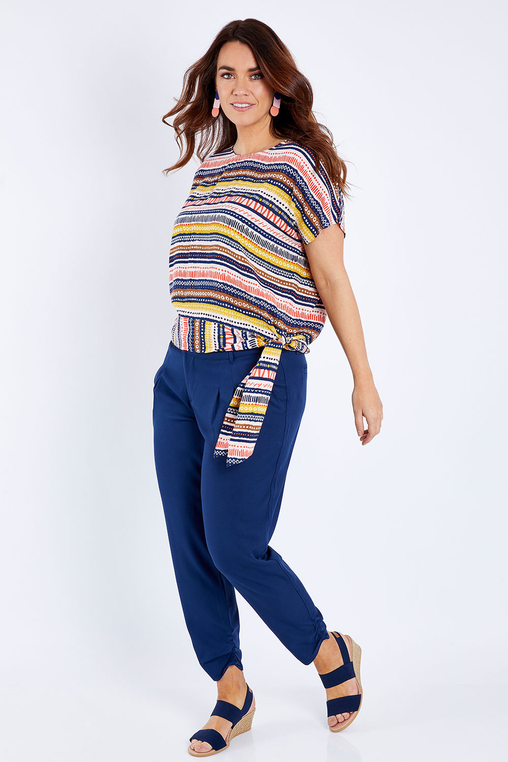 Model Laura wearing size 14 of the Striped Tie Waist Top in colour Tribal (Blue), from the front, showing the whole outfit