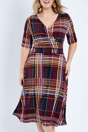 Model Jess wearing size 14 of the Printed Short Sleeve Faux Wrap Dress in colour Checked (Black), from the front, cropped image