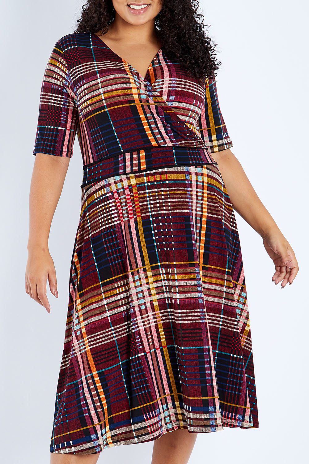 Model Sasha-Lee wearing size 16 of the Printed Short Sleeve Faux Wrap Dress in colour Checked (Black), from the front, cropped image