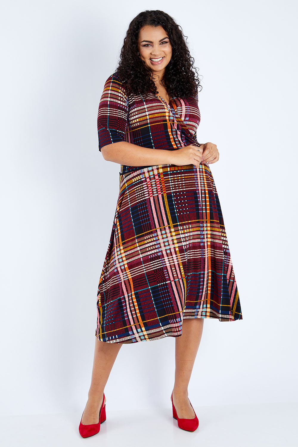 Model Sasha-Lee wearing size 16 of the Printed Short Sleeve Faux Wrap Dress in colour Checked (Black), from the front, showing the whole outfit