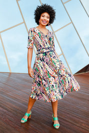 Model Olivia wearing size 10 of the Printed Short Sleeve Faux Wrap Dress in colour Colourful (Blue), from the front, showing the whole outfit