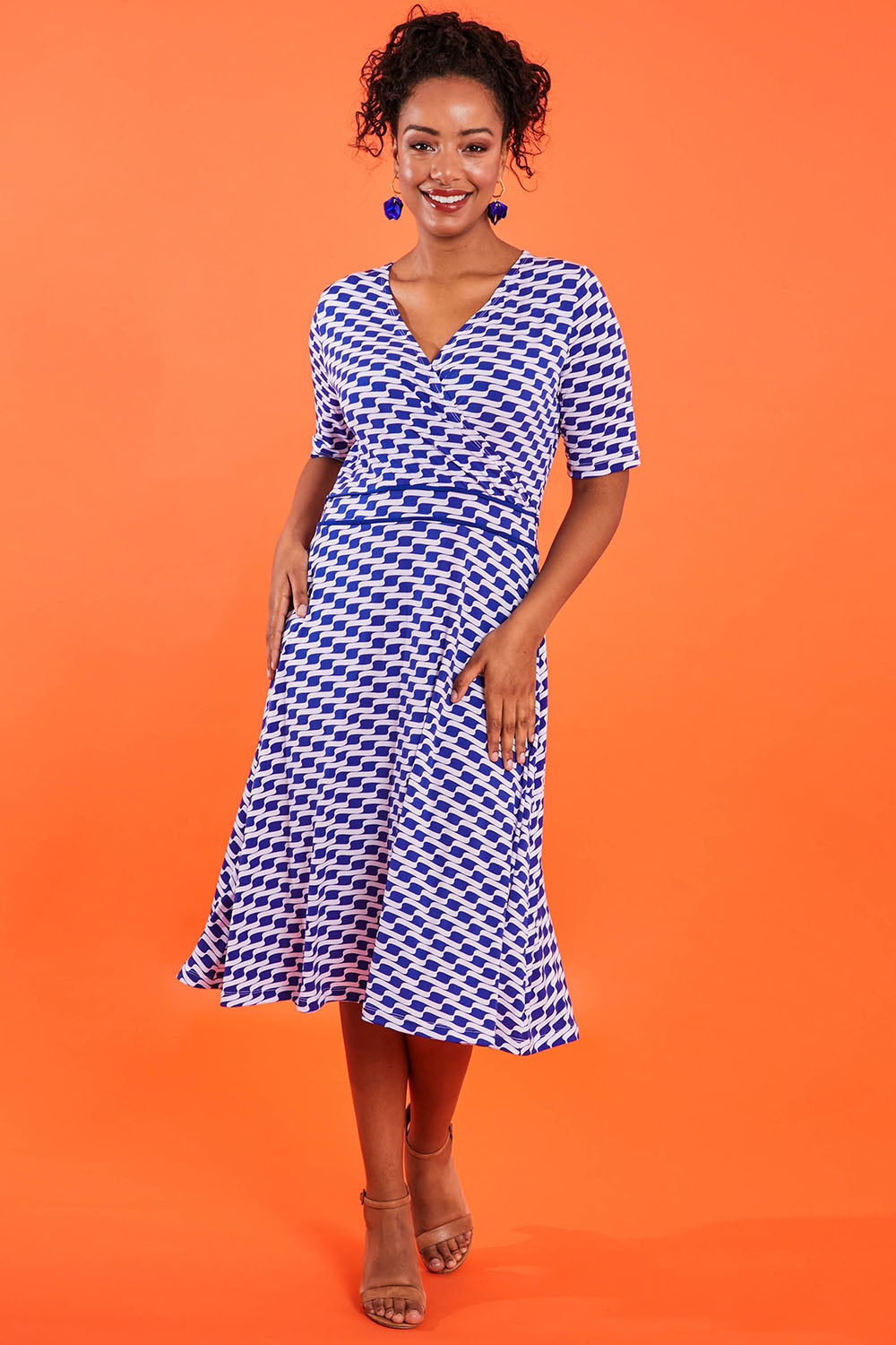 Model Noli wearing size 14 of the Printed Short Sleeve Faux Wrap Dress in colour Waves (Blue), from the front, showing the whole outfit