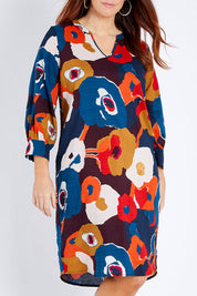 Model Laura wearing size 14 of the Long Sleeve Relaxed Fit Dress in colour Autfloral (Blue), from the front, cropped image