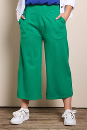 Model Georgiel wearing size 10 of the Wide Leg Ponte Pant – Green in colour Green, from the front
