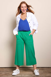 Model Georgiel wearing size 10 of the Wide Leg Ponte Pant – Green in colour Green, from the front