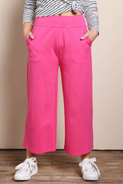 Model Georgiel wearing size 10 of the Wide Leg Ponte Pant – Pink in colour Pink, in a cropped view