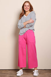 Model Georgiel wearing size 10 of the Wide Leg Ponte Pant – Pink in colour Pink, from the front