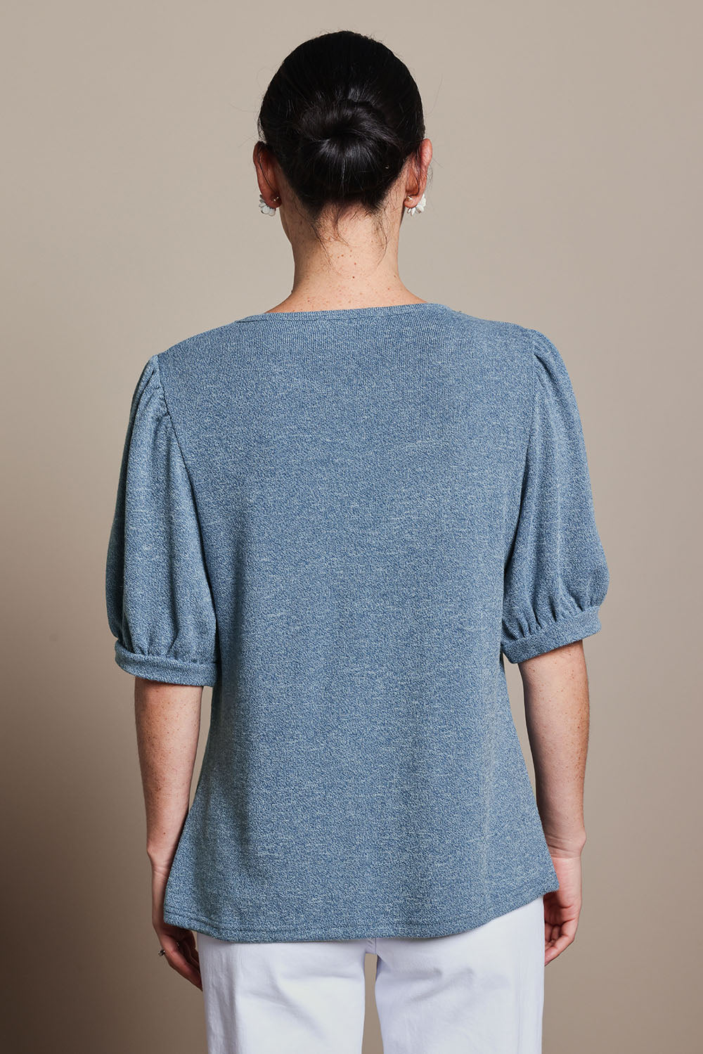 Model Katie wearing size 10 of the Gathered Sleeve Top in colour Denim (Blue), from the back