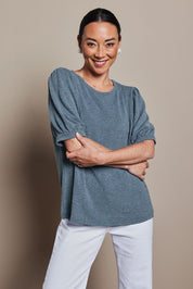 Model Katie wearing size 10 of the Gathered Sleeve Top in colour Denim (Blue), from the front, cropped image
