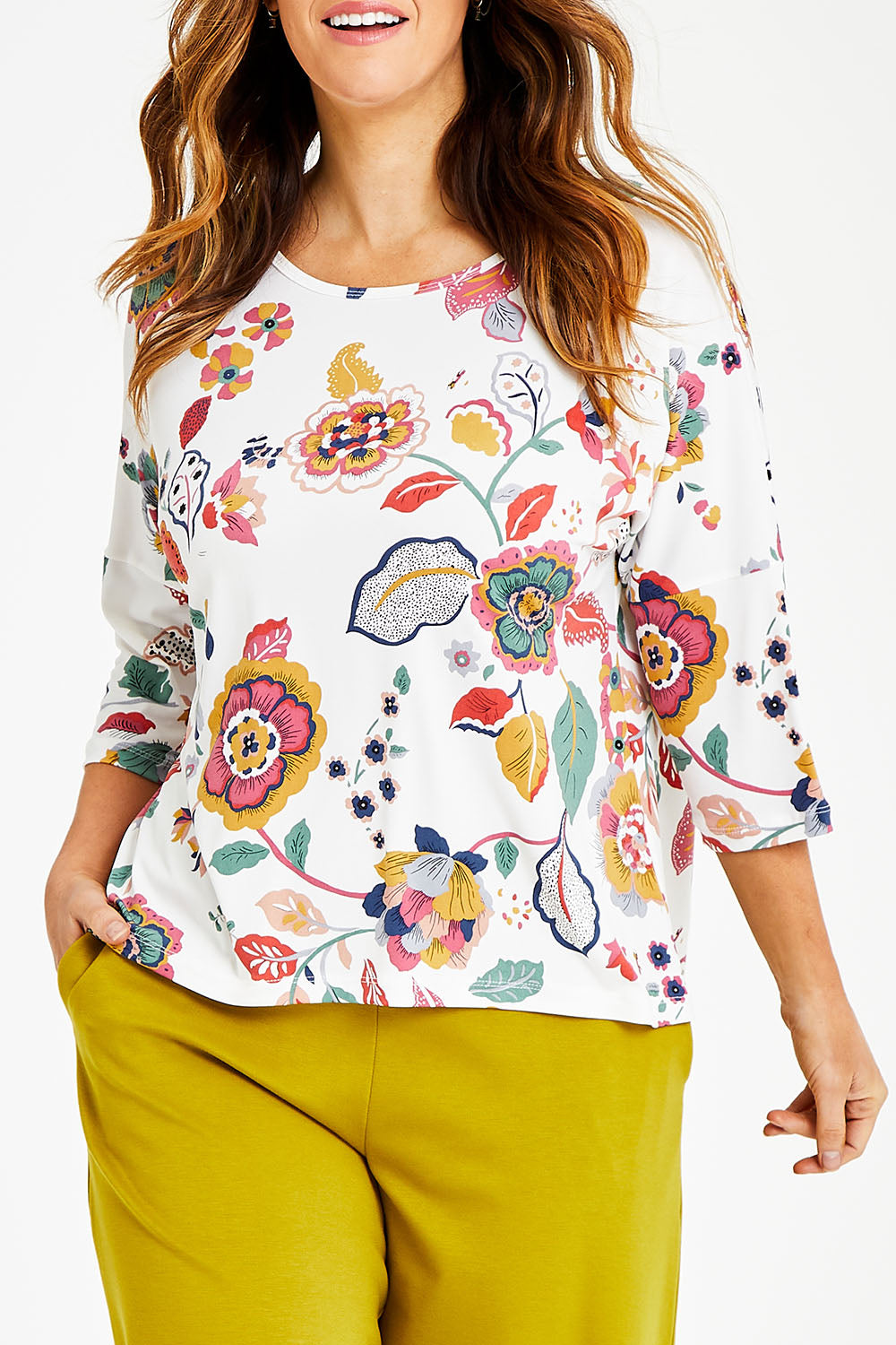Model Laura wearing size 14 of the Printed 3/4 Sleeve High Low Hem Top in colour Flora (White), from the front, cropped image