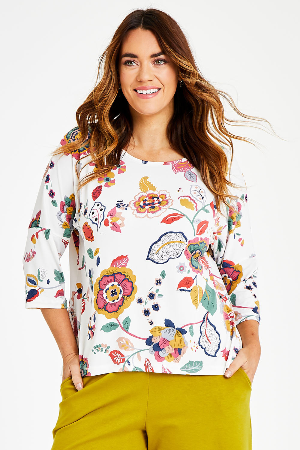 Model Laura wearing size 14 of the Printed 3/4 Sleeve High Low Hem Top in colour Flora (White), from the front, cropped image