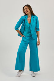 Model Amanda wearing size 10 of the Wide Leg Pant in colour Turquoise (Blue), from the front, showing the whole outfit