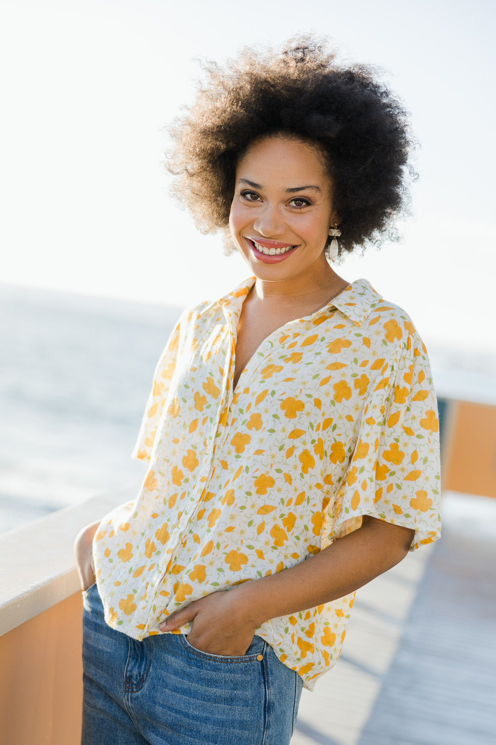 Model Olivia wearing size 10 of the Printed Button Thru Blouse in colour Goldfloral, from the front, showing the whole outfit