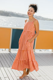 Model Olivia wearing size 10 of the Printed Tiered Maxi Dress in colour Retrostar (Red), from the front, showing the whole outfit