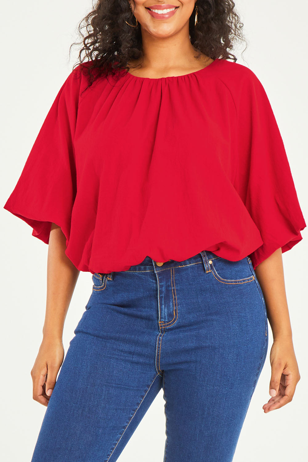 Model Noli wearing size 14 of the Billow Sleeve Top in colour Red (Red), from the front, cropped image