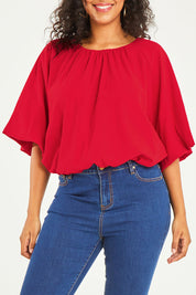 Model Noli wearing size 14 of the Billow Sleeve Top in colour Red (Red), from the front, cropped image
