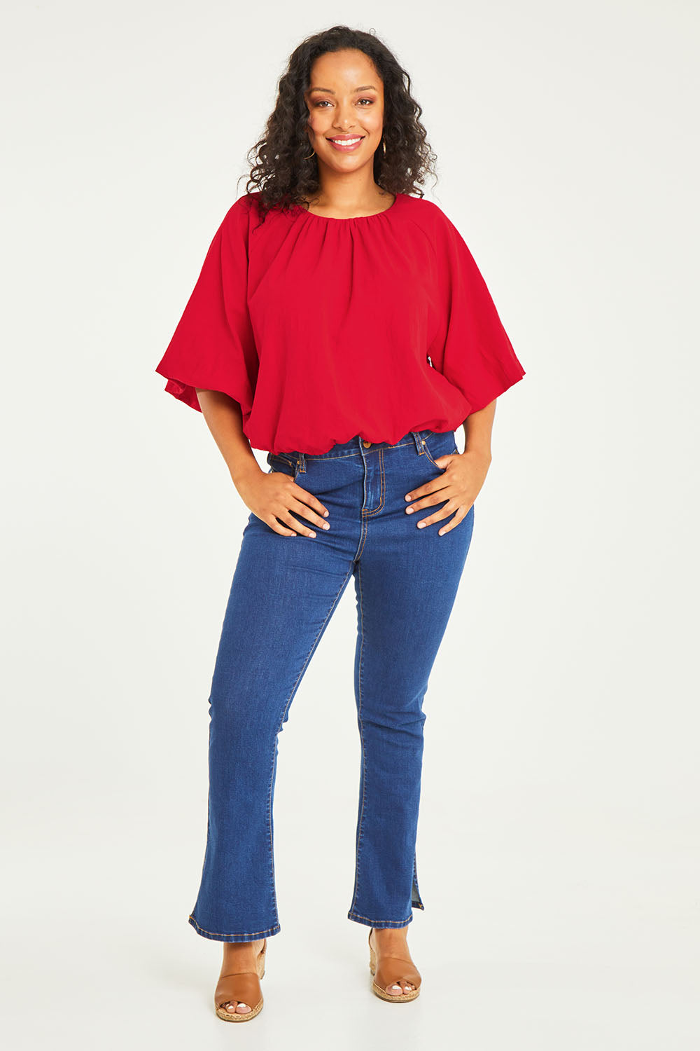 Model Noli wearing size 14 of the Billow Sleeve Top in colour Red (Red), from the front, showing the whole outfit