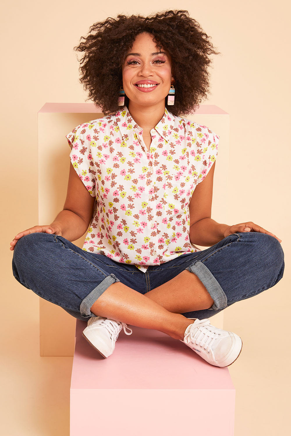 Model Olivia wearing size 10 of the Cap Sleeve Shirt in colour Retrodaisy (White), from the front, showing the whole outfit